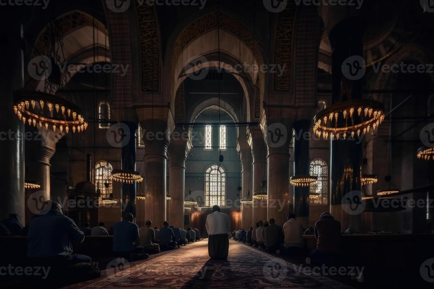 Rear view of a man praying in a Muslim mosque. Huge Arabian architecture with beautiful ceiling rose light. Muslims are praying in a huge mosque. Islamic holy place rear view. . photo