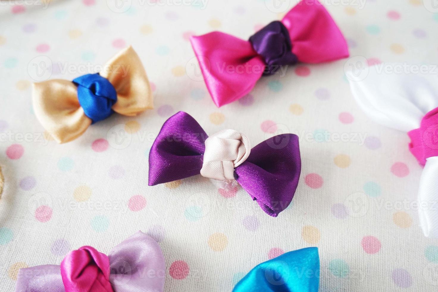 Colorful bow tie on white fabric with polka dot background. photo