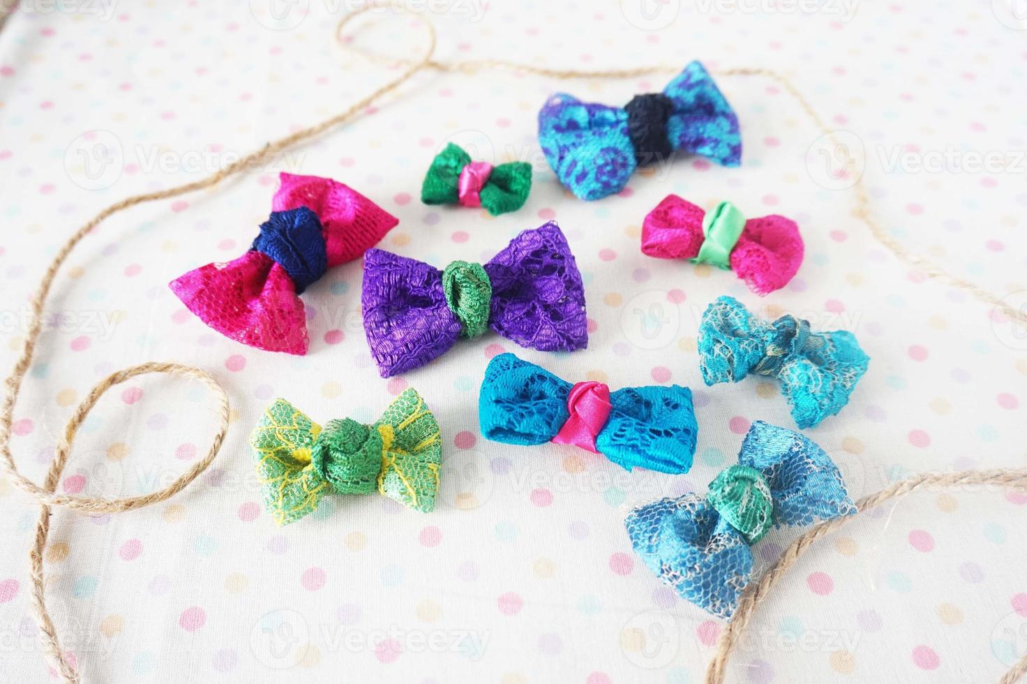 Colorful bow tie on white fabric with polka dot background. photo