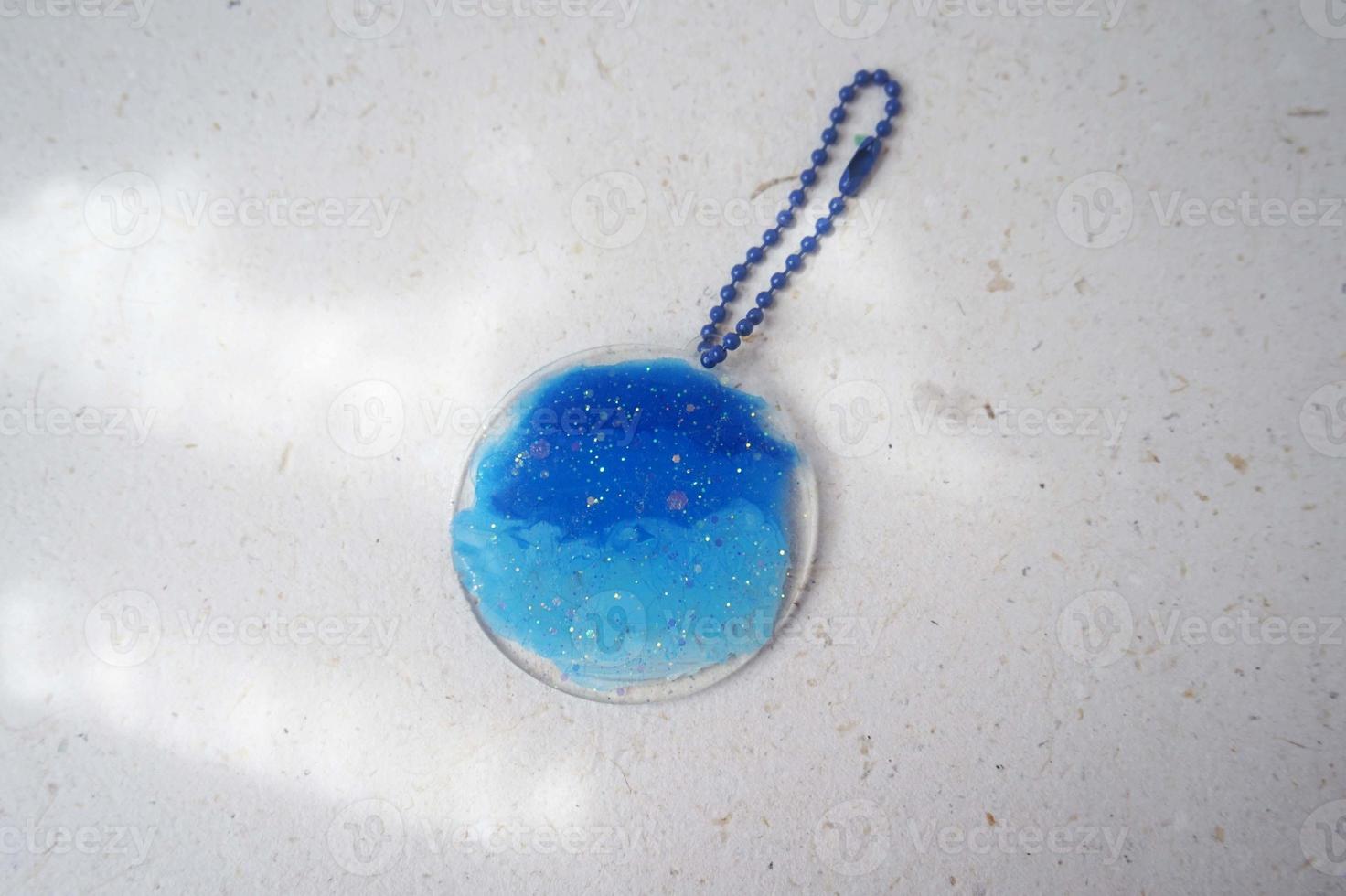 Colorful pendant painted in watercolor in the shape of a lines on a white background photo