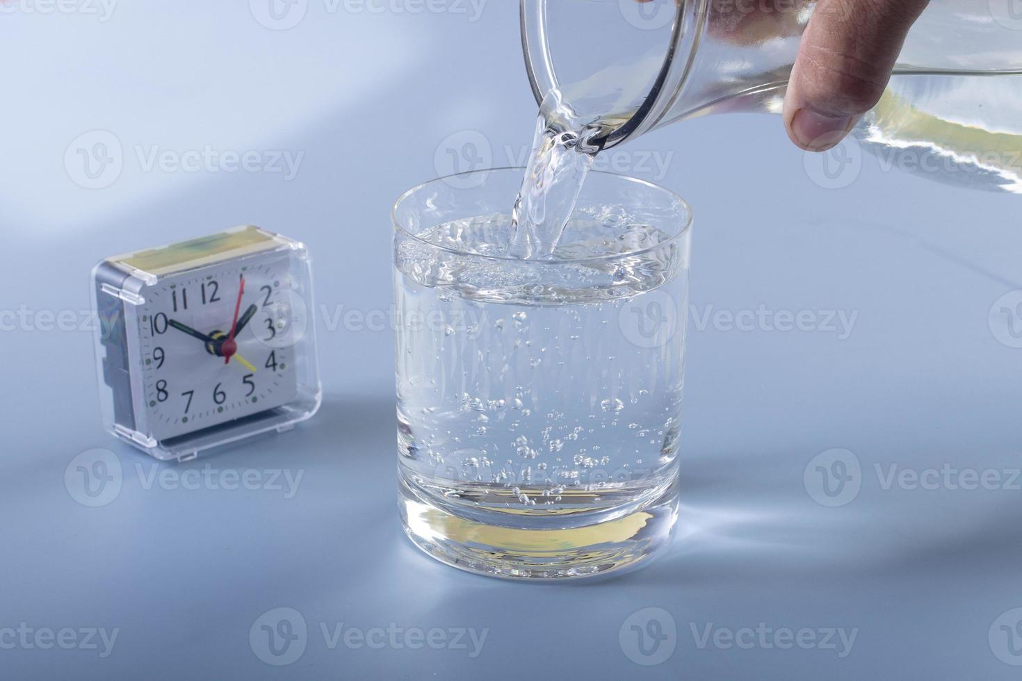 Detail of person filling glass of water. hydration concept photo