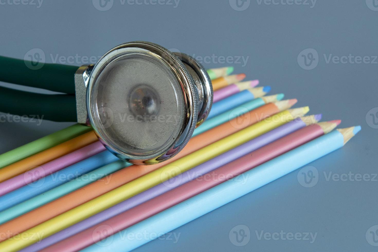 Sample of colored pencils and a stethoscope representing the pediatric doctor photo