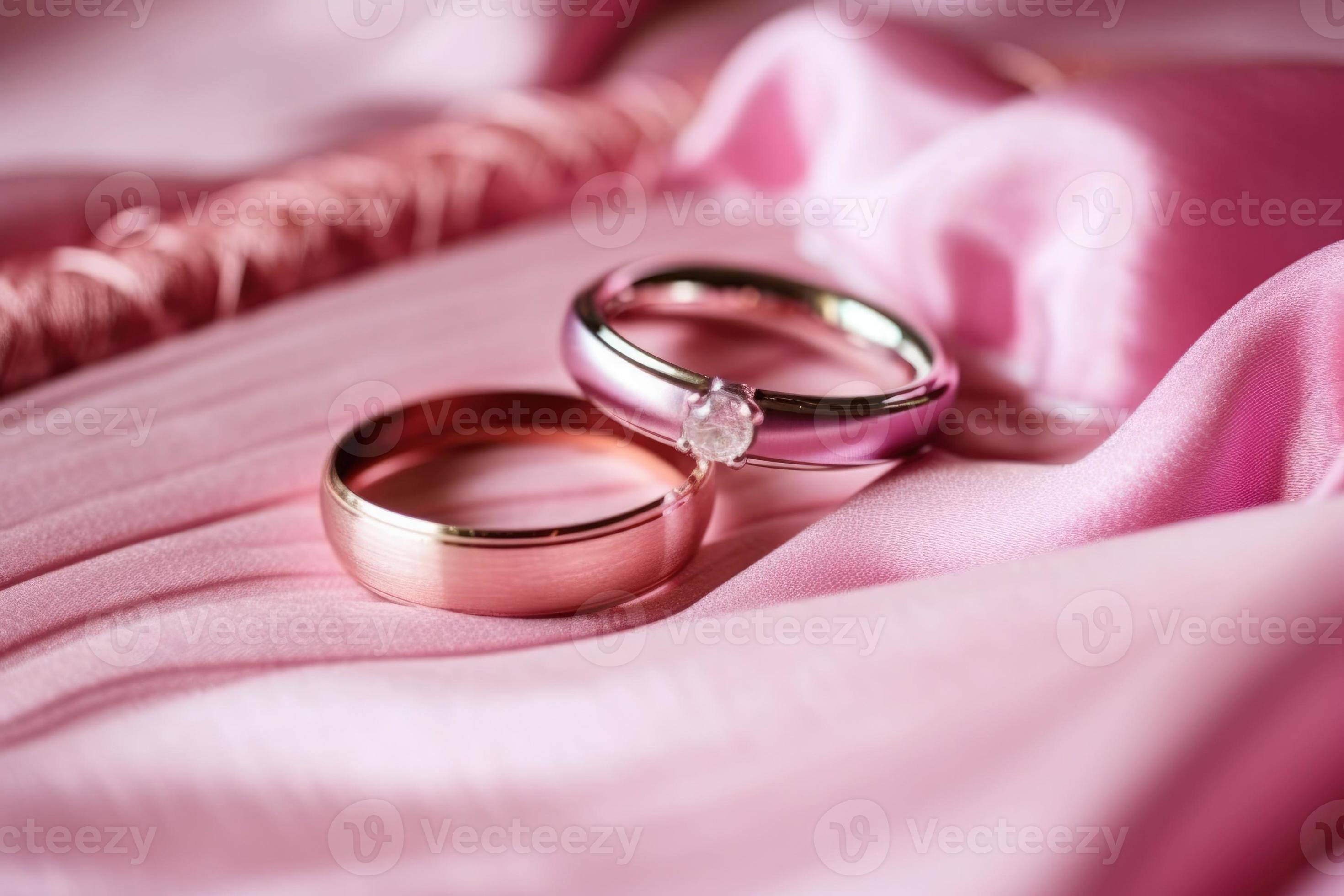 Gold wedding rings with pink silk background 22263643 Stock Photo at