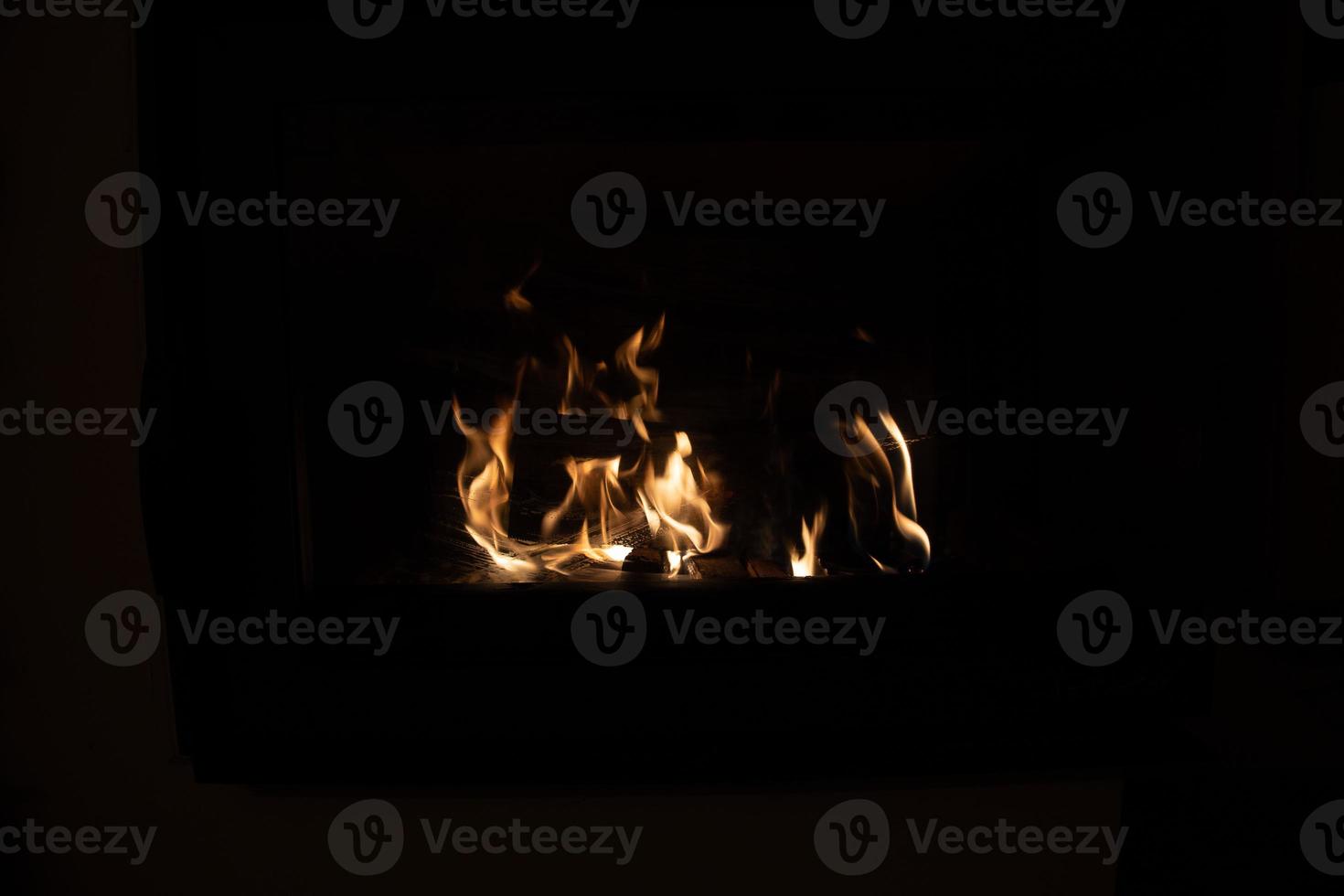 hot fire burning in a domestic fireplace on a winter day photo