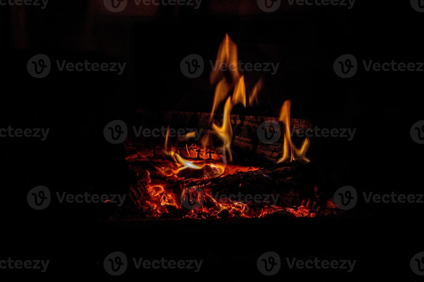 hot fire burning in a domestic fireplace on a winter day photo