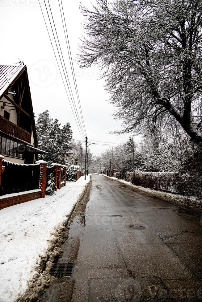 narrow estate road in the city during snowfall photo