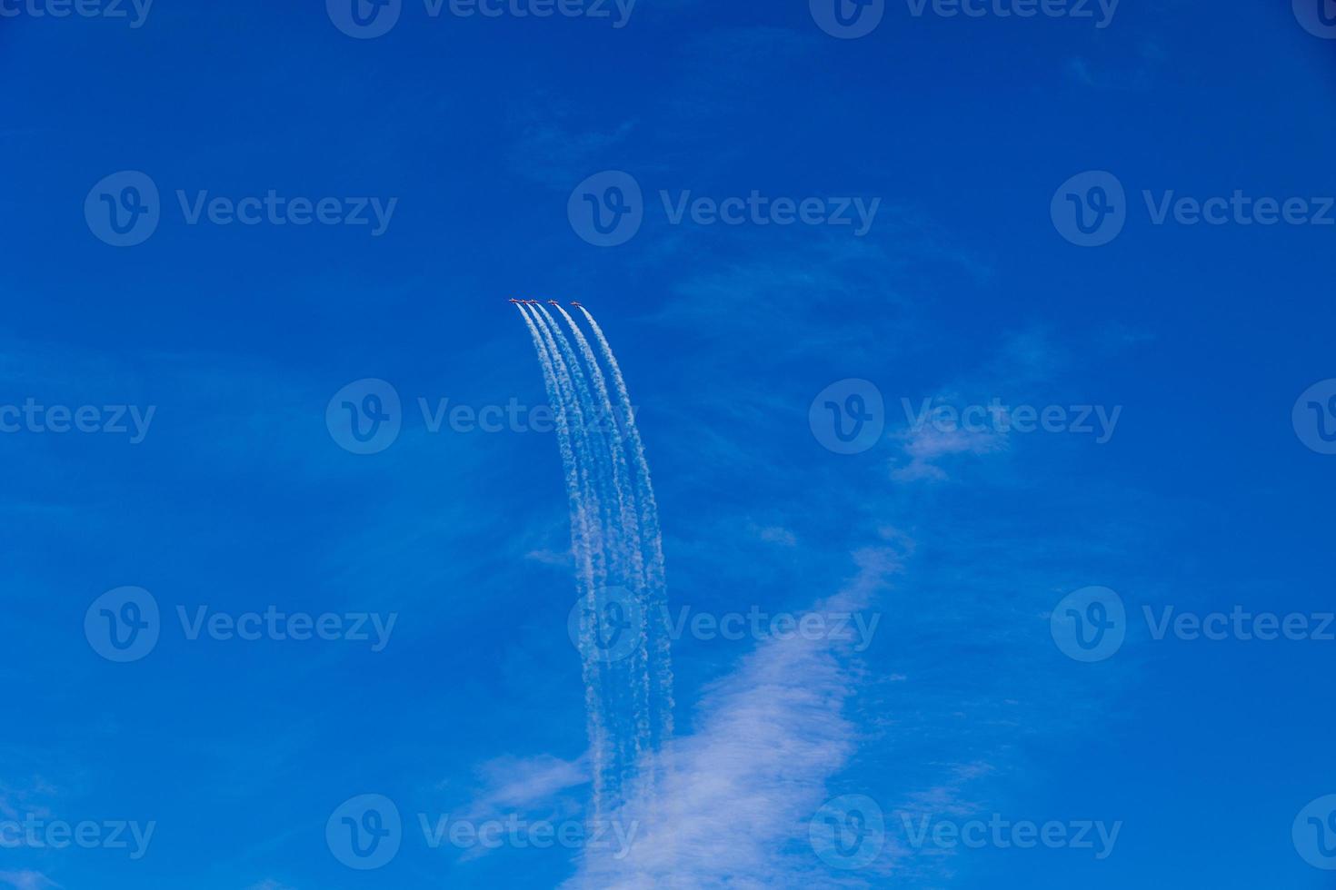 flight of five cessna planes over alicante smoke spanish flag against the blue sky photo