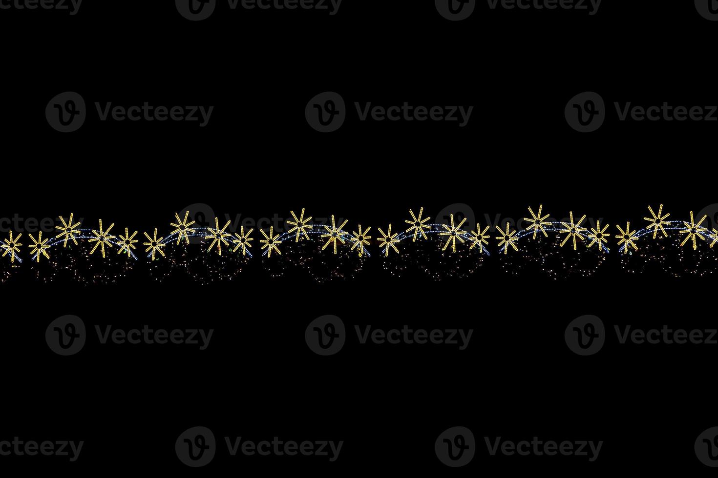 gold light decoration for christmas on black background photo