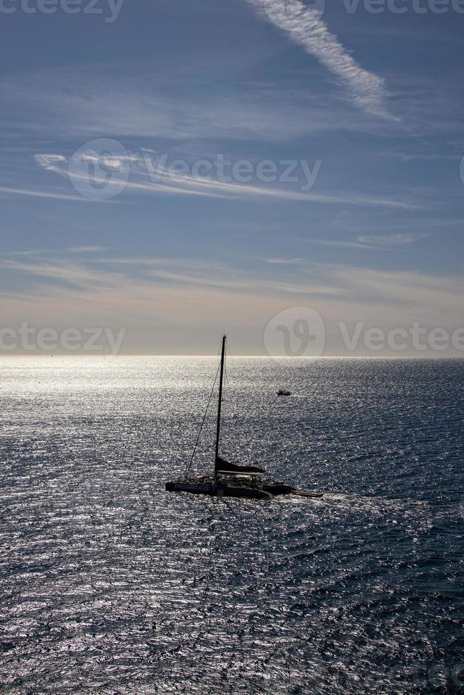 sea landscape on a sunny day with blue sky and water and a sailing ship photo