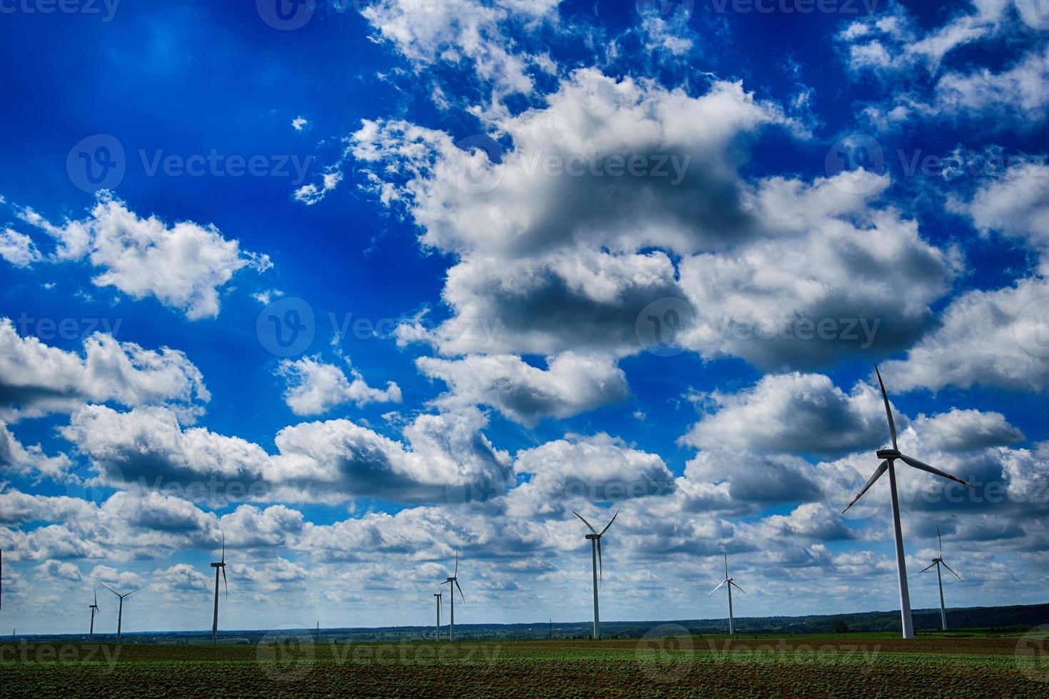 picturesque spring landscape with blue sky and green fields photo