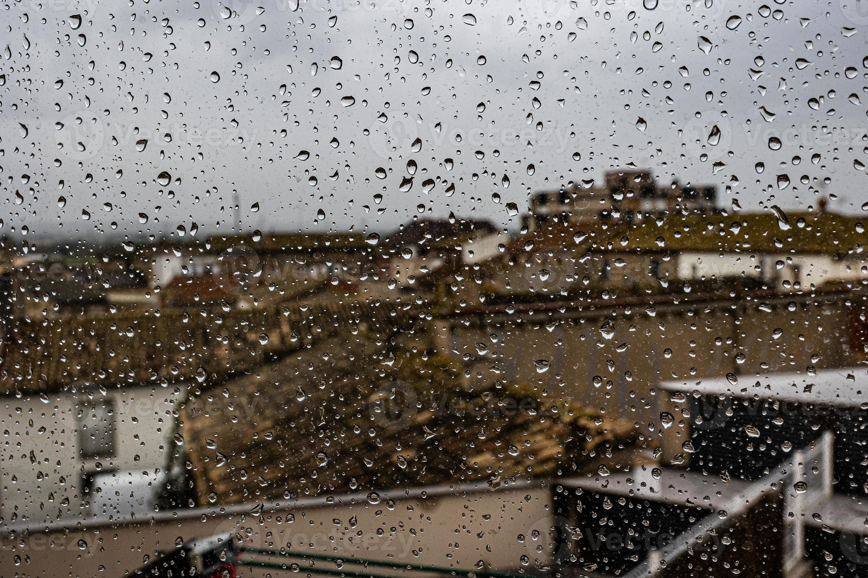 background glass pane in drops of water with a view of the spanish