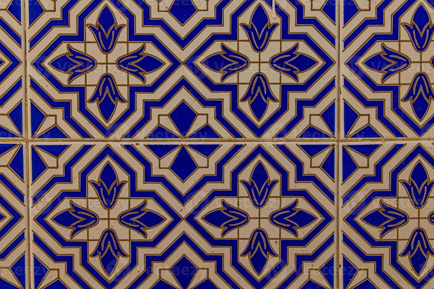 background of white-blue ceramic tiles with classic spanish patterns photo