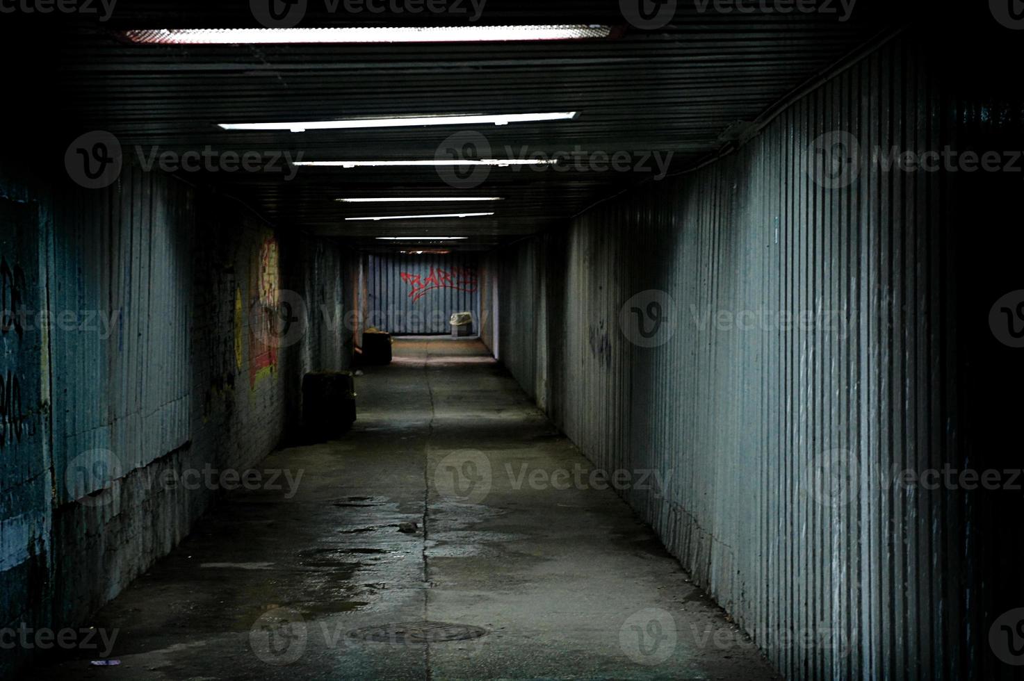 abandoned urban underground passage with graffiti on the wall photo