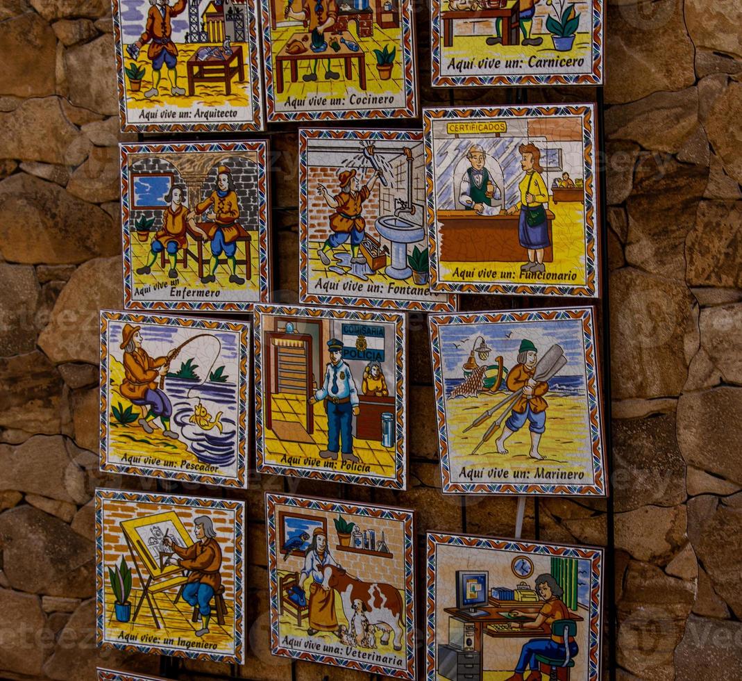 ceramic tiles souvenirs in a shop in the south of spain in a tourist town, colorful art crafts background photo