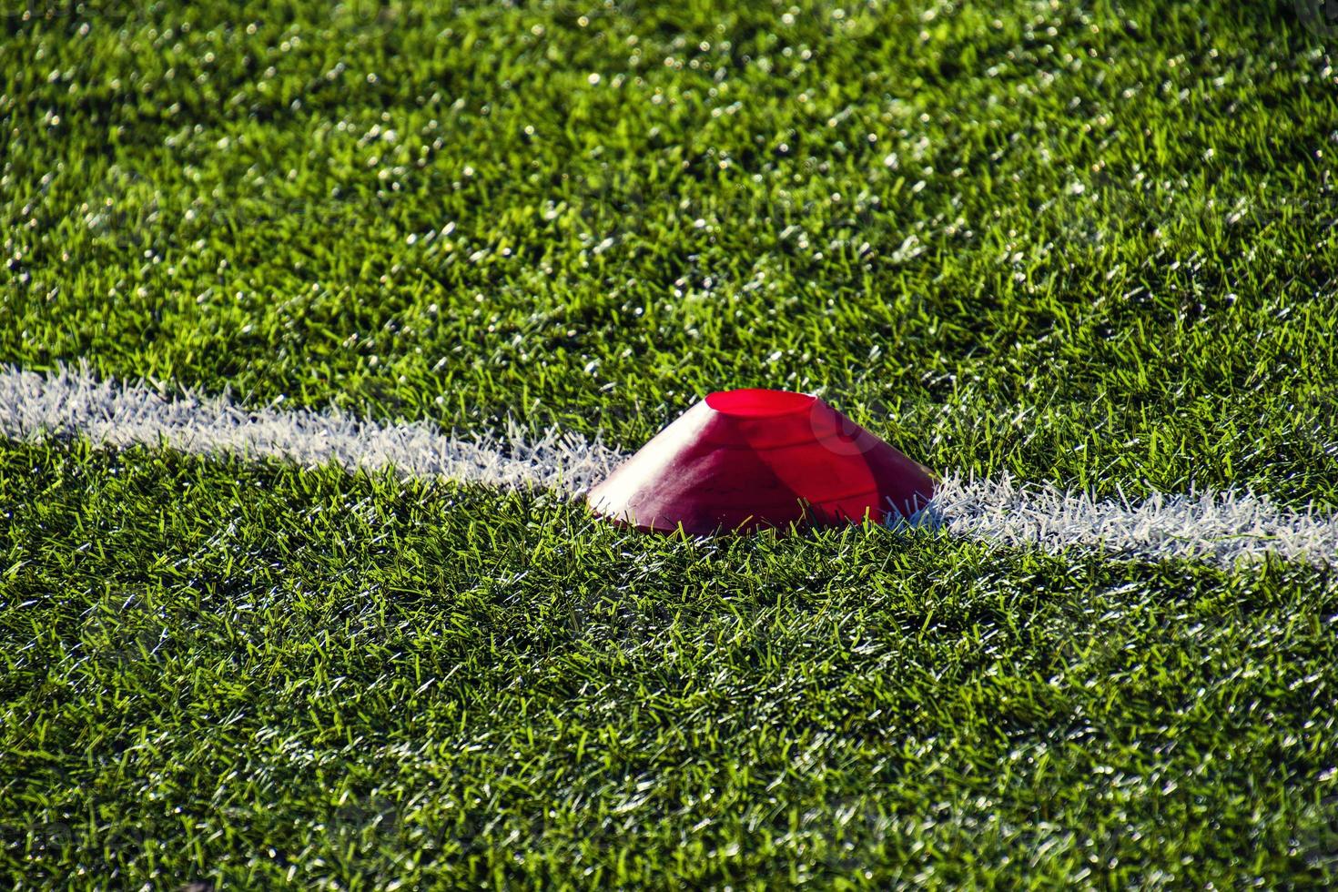 training football pitch with artificial green grass and training aids illuminated by the afternoon  sun photo