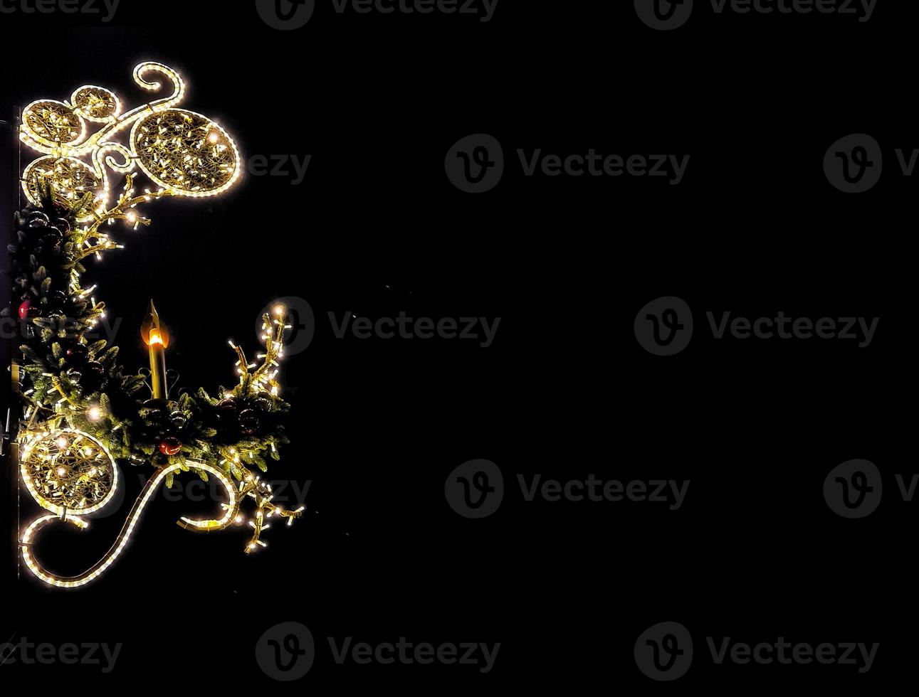 light illumination for christmas decorative candle on black smooth background photo