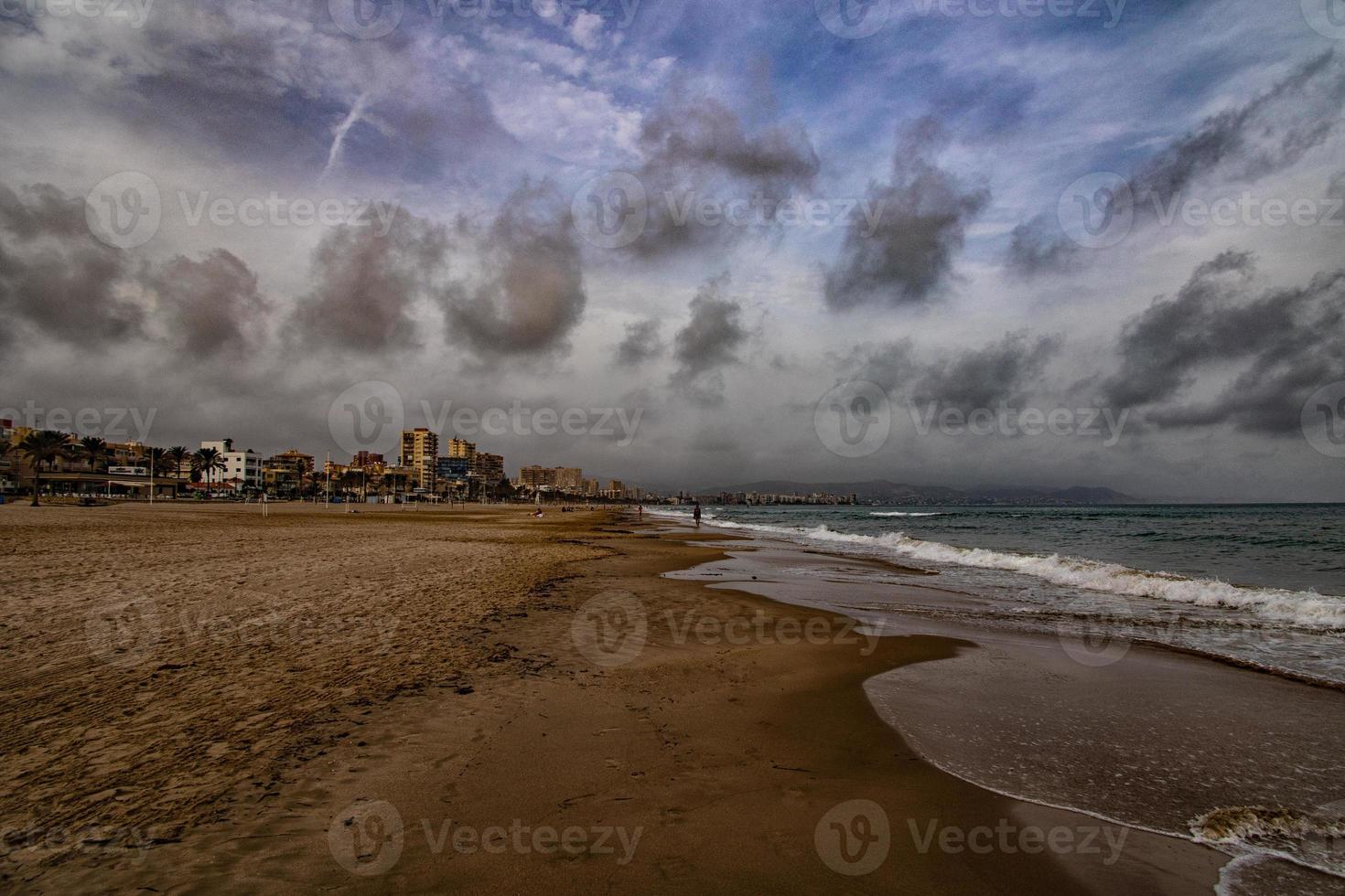 landscape wide sandy beach in alicante autumn day clouds photo