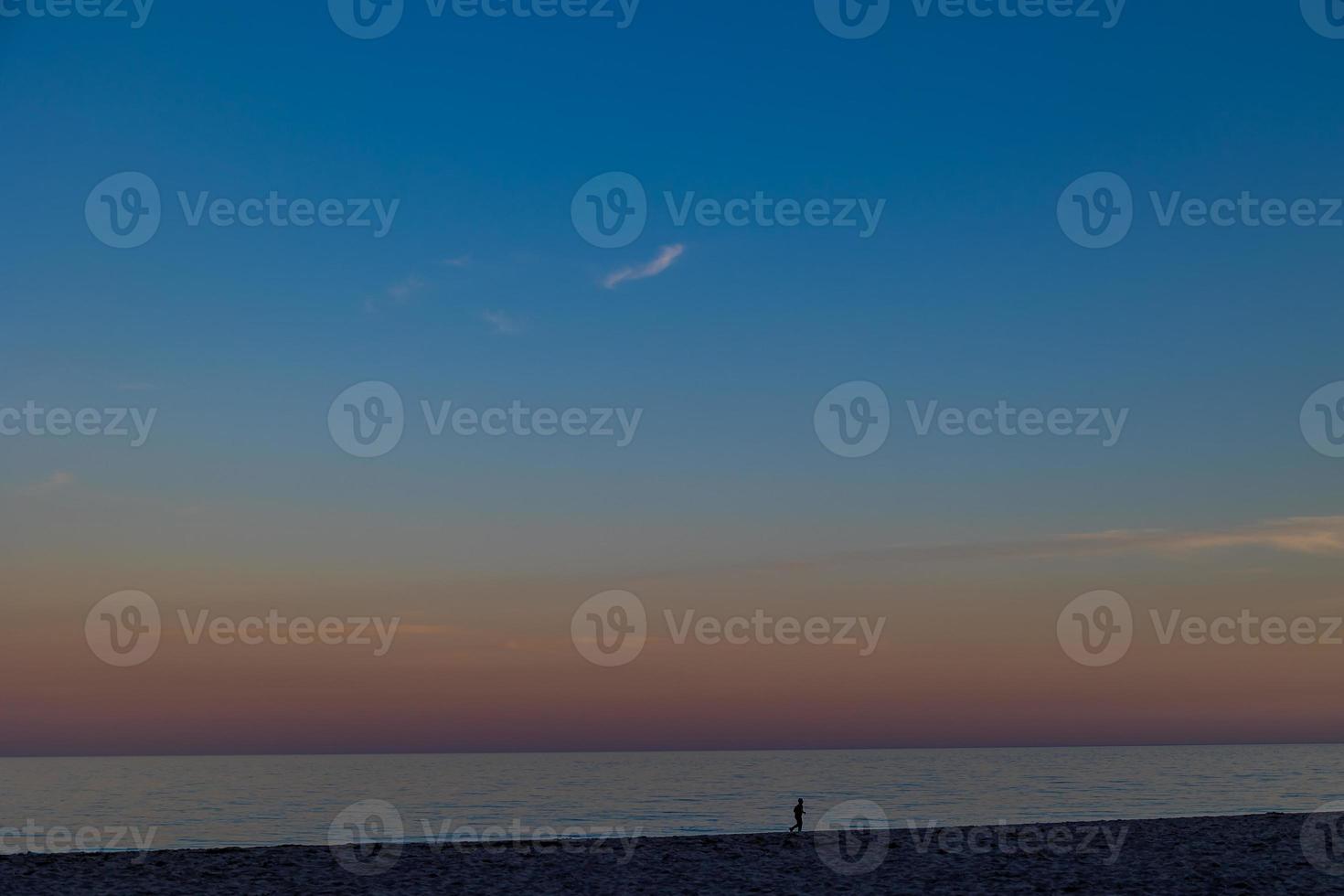 seaside landscape peace and quiet on a sunny warm day with a walking man minimalism photo