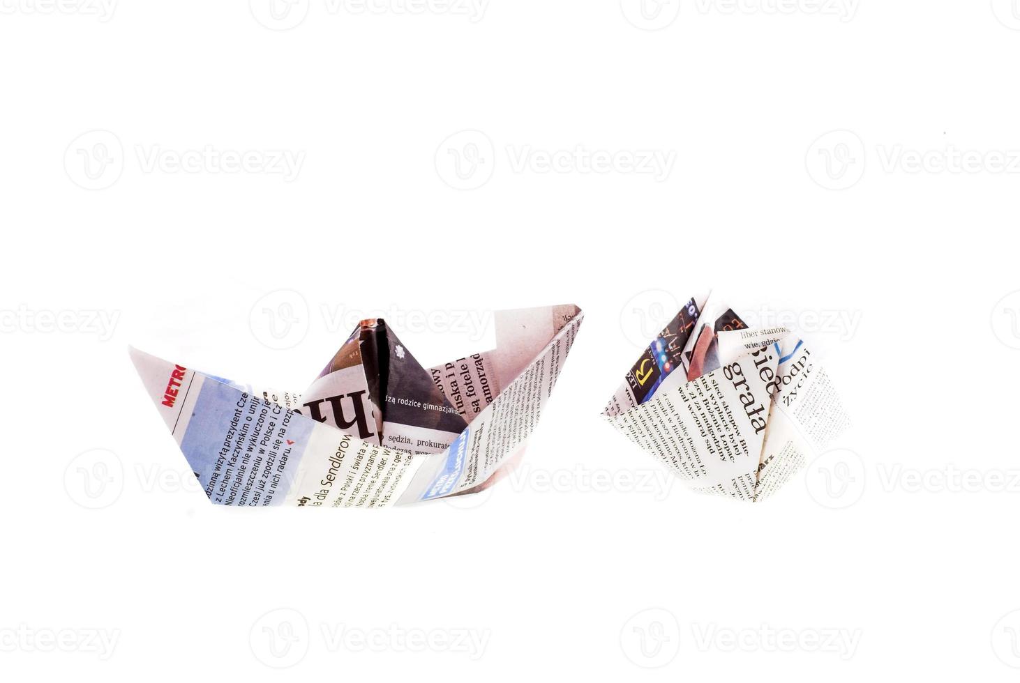 origami ship from newspaper on white background photo