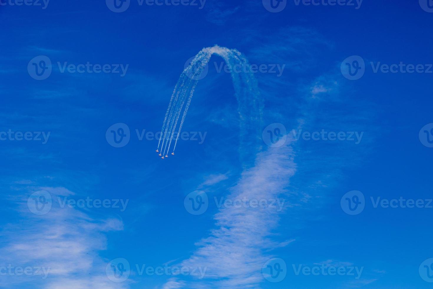 flight of five cessna planes over alicante smoke spanish flag against the blue sky photo