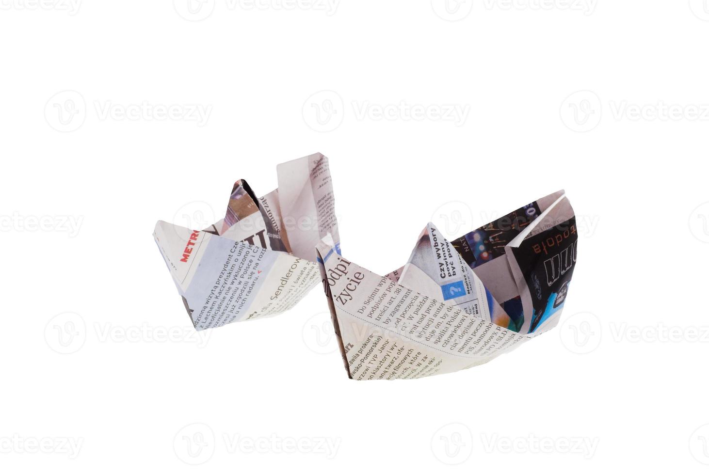 origami ship from newspaper on white background photo