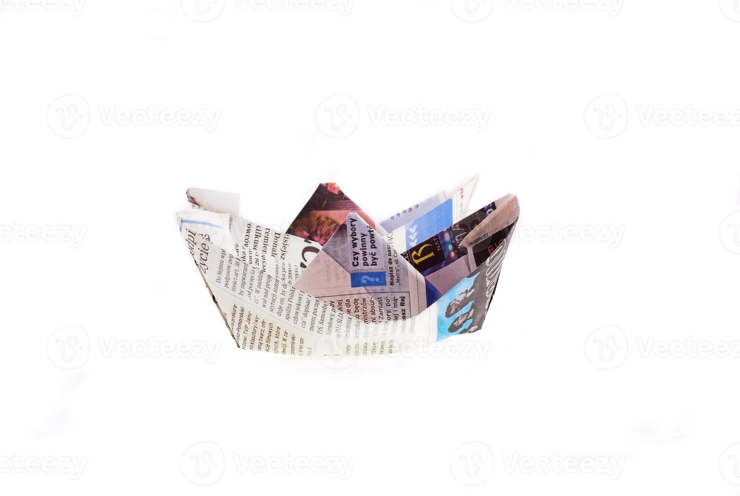 origami ship from newspaper on white background photo