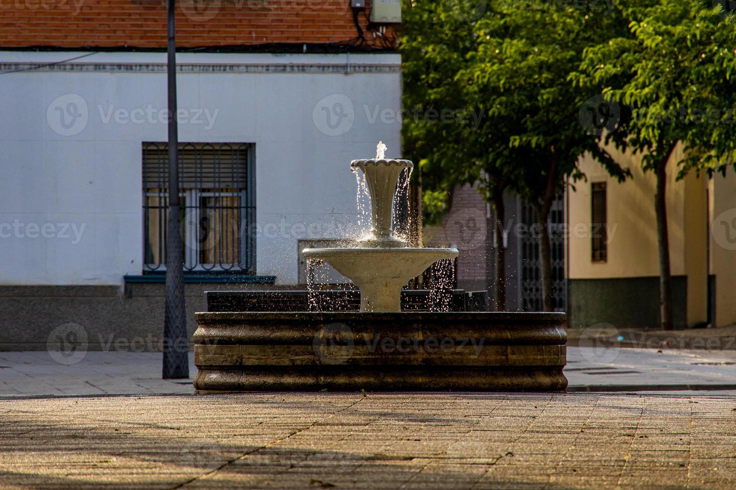 fountain in a spanish small town on a summer day in the urban landscape photo