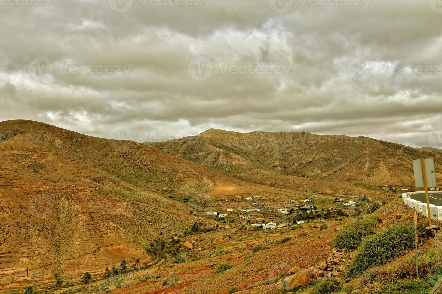 empty mysterious mountainous landscape from the center of the Canary Island Spanish Fuerteventura with a cloudy sky photo