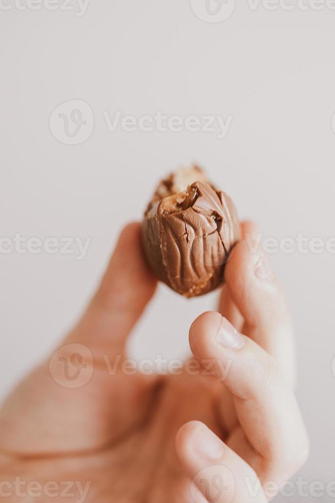 little bitten chocolate easter egg in a child's hand photo