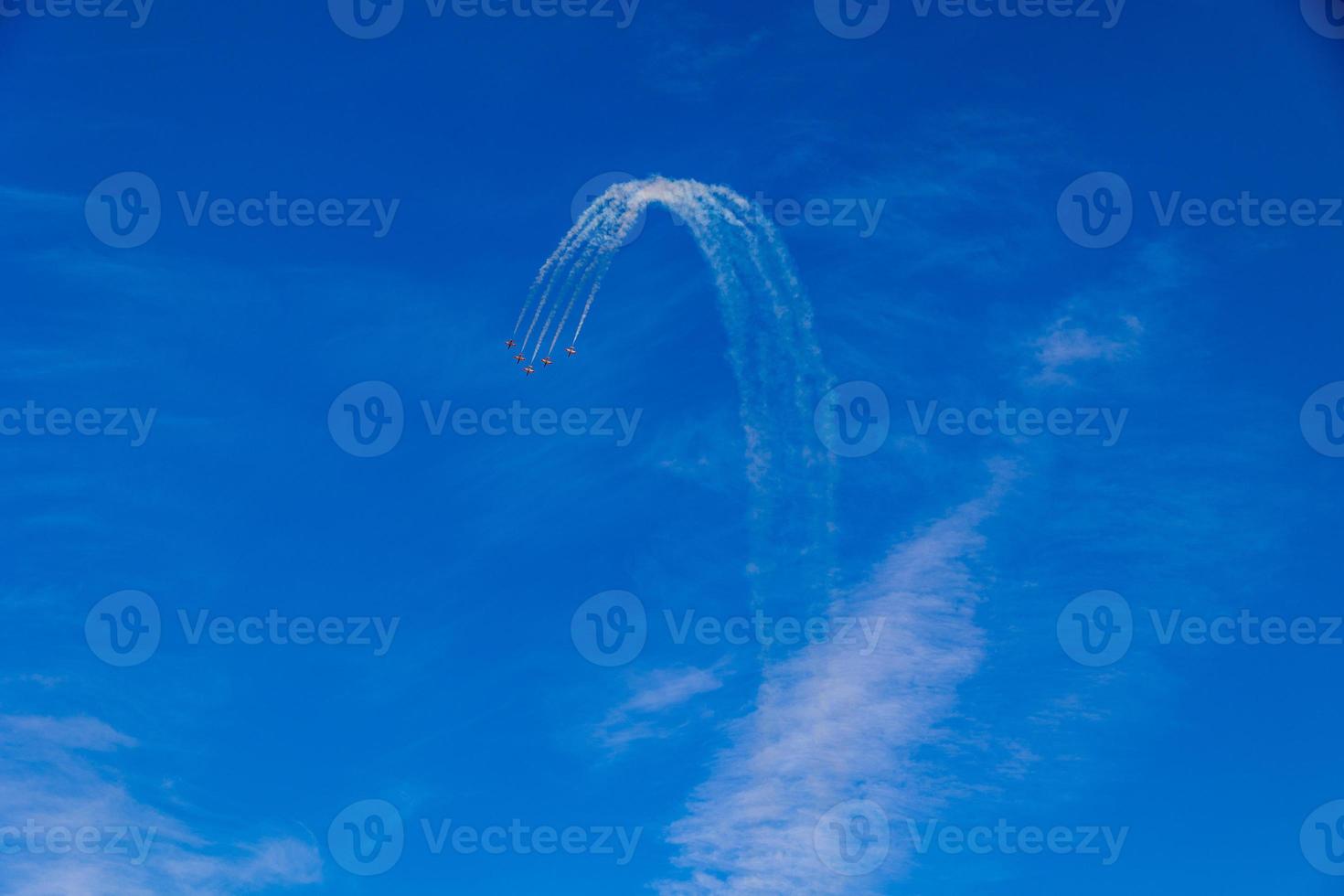 flight of five cessna planes over alicante smoke spanish flag against the blue sky photo