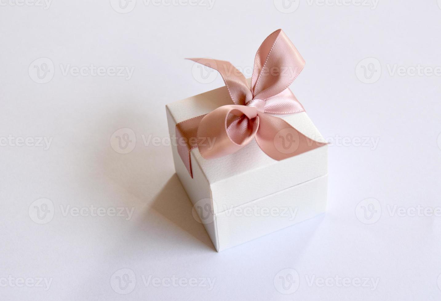 a gift in a white box with a pink bow photo