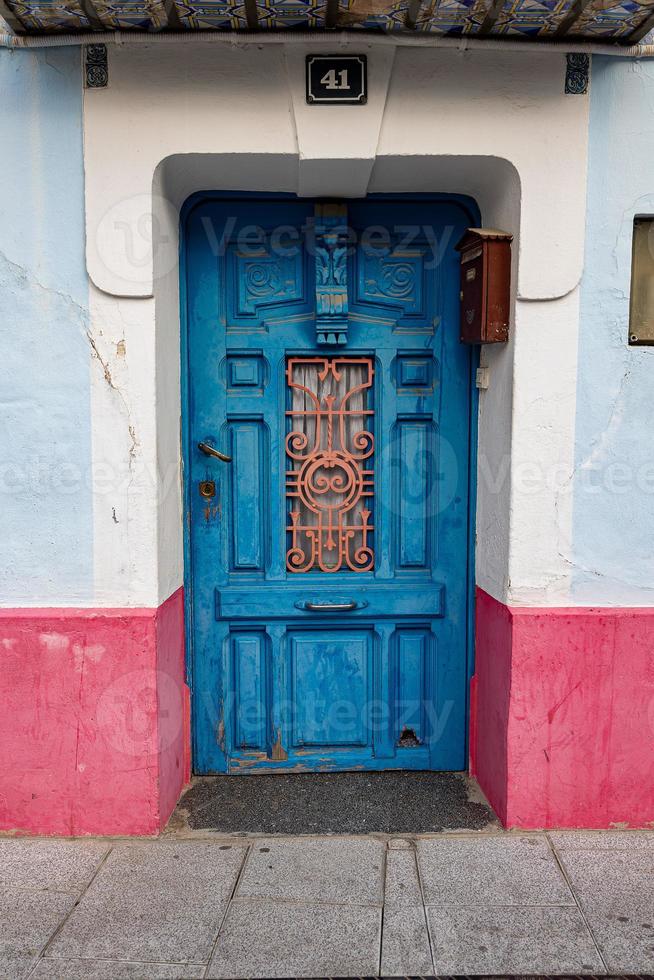 old antique blue wooden door in a tenement house photo