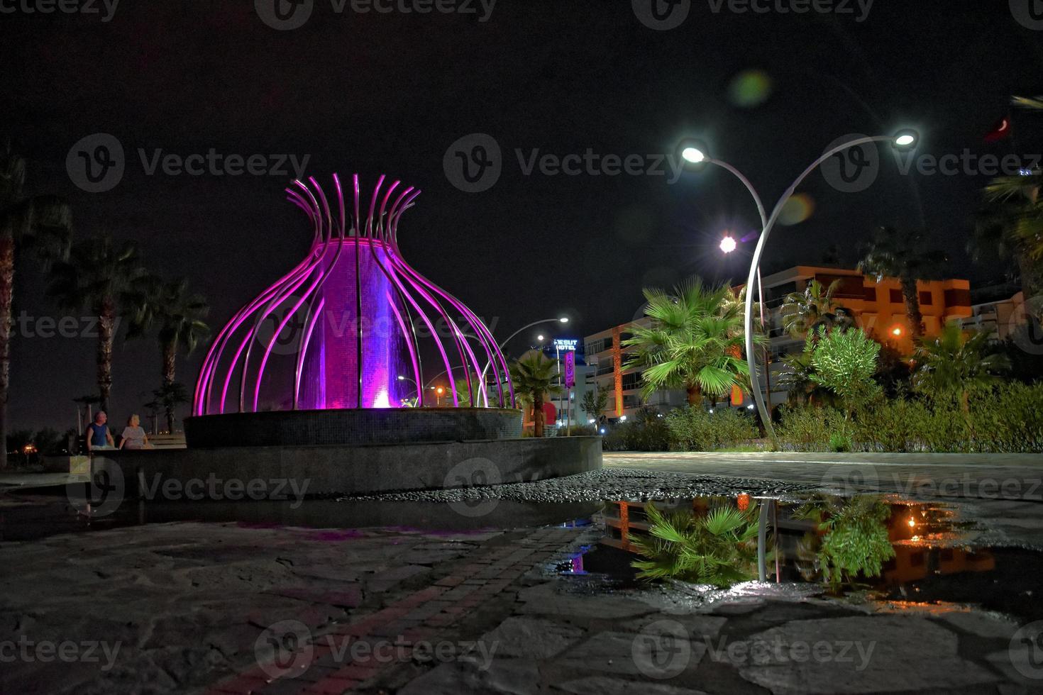 night view of the turkish city of alanya with lights on the hill photo