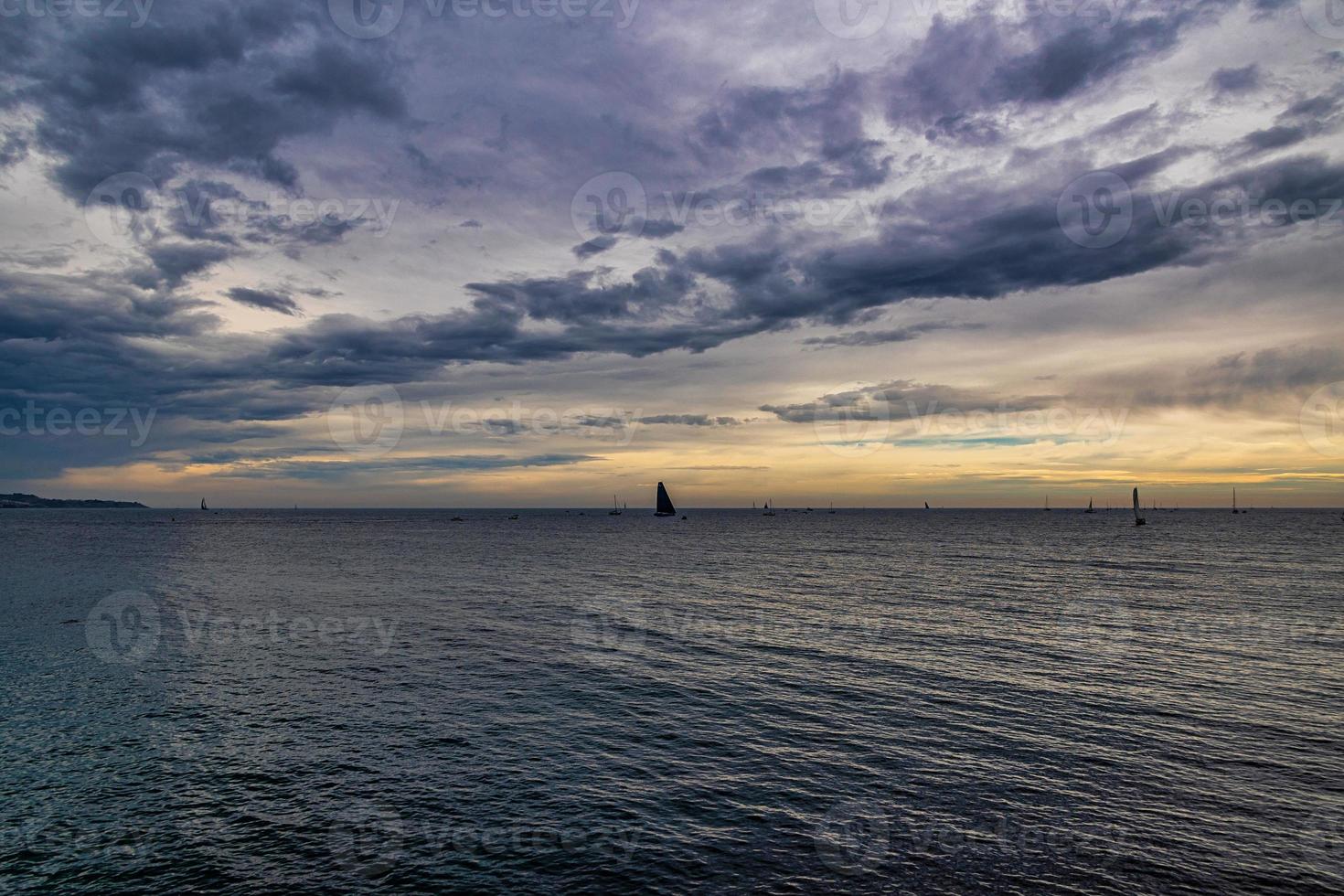 seaside landscape with clouds and sailboat on the horizon Alicante Spain photo