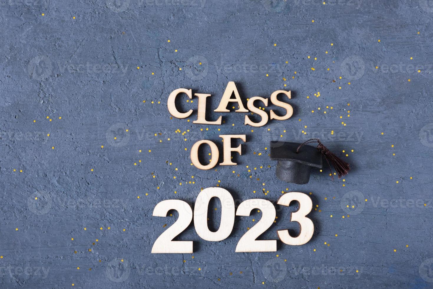 Class of 2023 concept. Wooden number 2023 with tinsel on dark background flat lay photo