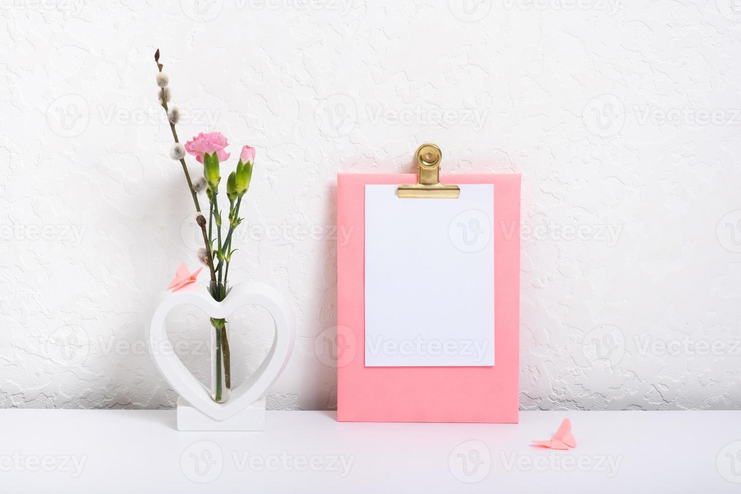 Message board mockup with creative plaster heart shape vase with flowers and butterflies photo