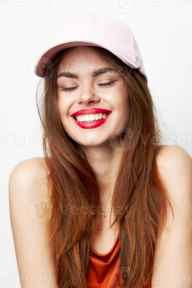 mujer en un gorra amplio sonrisa cerrado ojos desnudo espalda rojo vestir foto