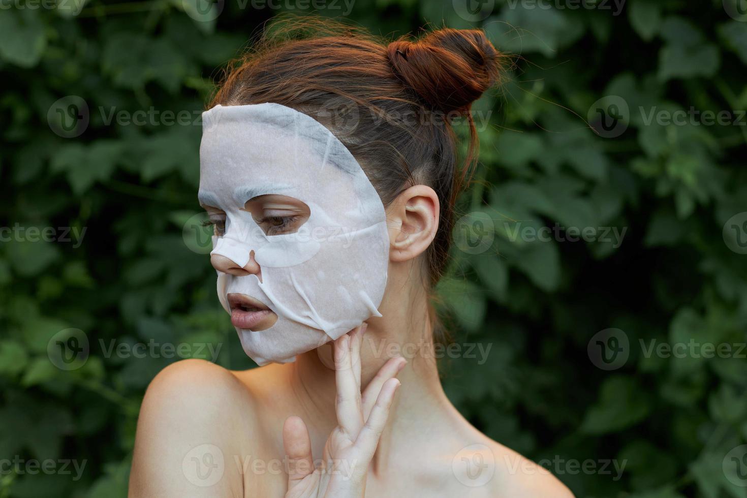 Beautiful woman face mask Holds hand near neck front view dermatology photo