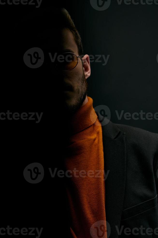 silhouette of a man in a sweater and jacket on a black background falling shadow photo