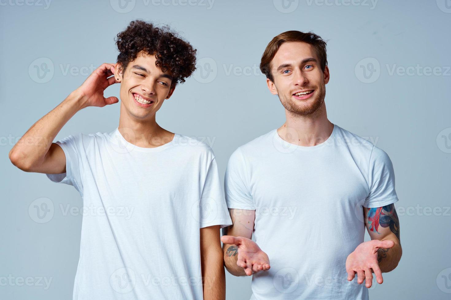 emotional two friends in white t-shirts yes fun studio photo