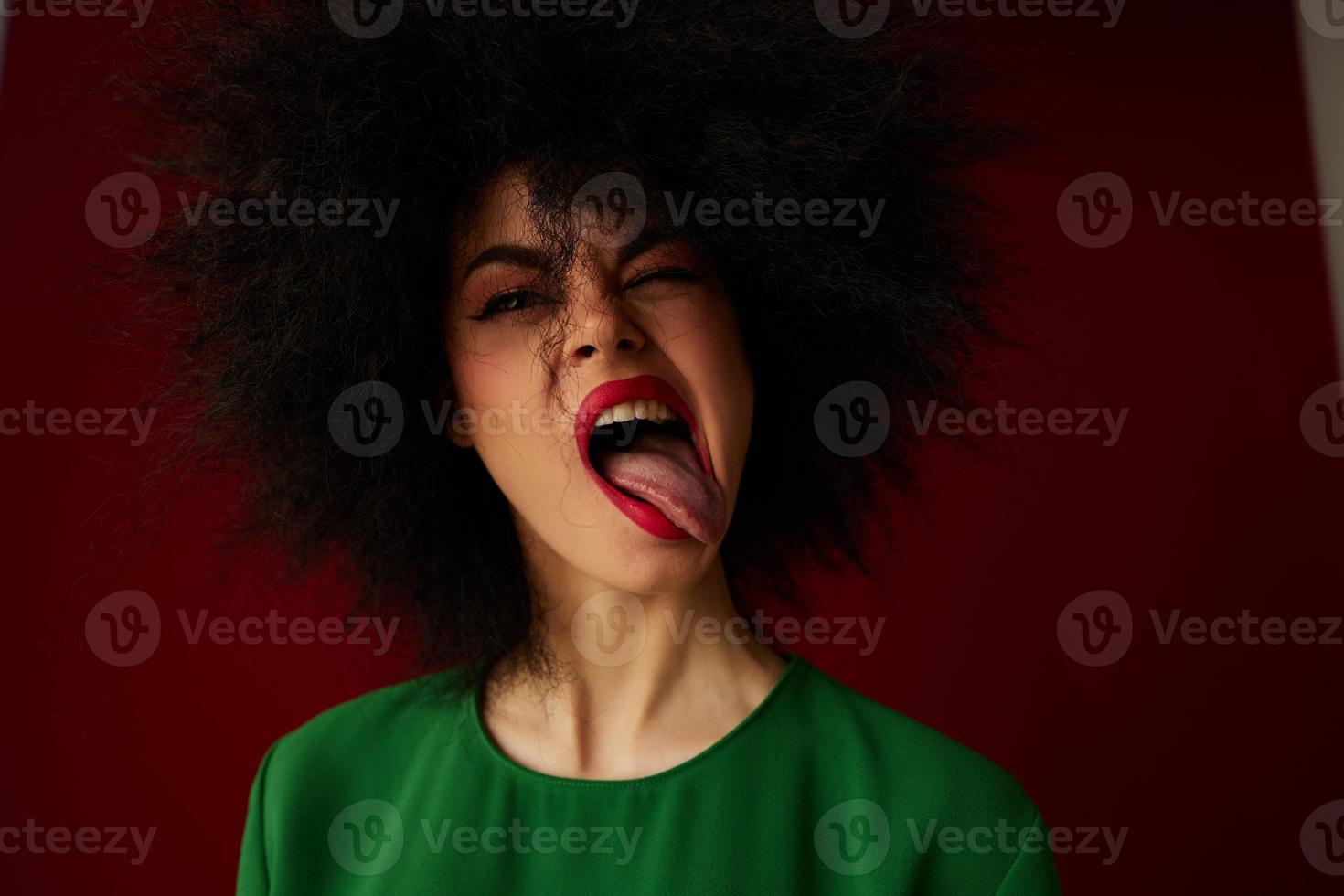 Beautiful fashionable girl Afro hairstyle green dress emotions close-up studio model unaltered photo