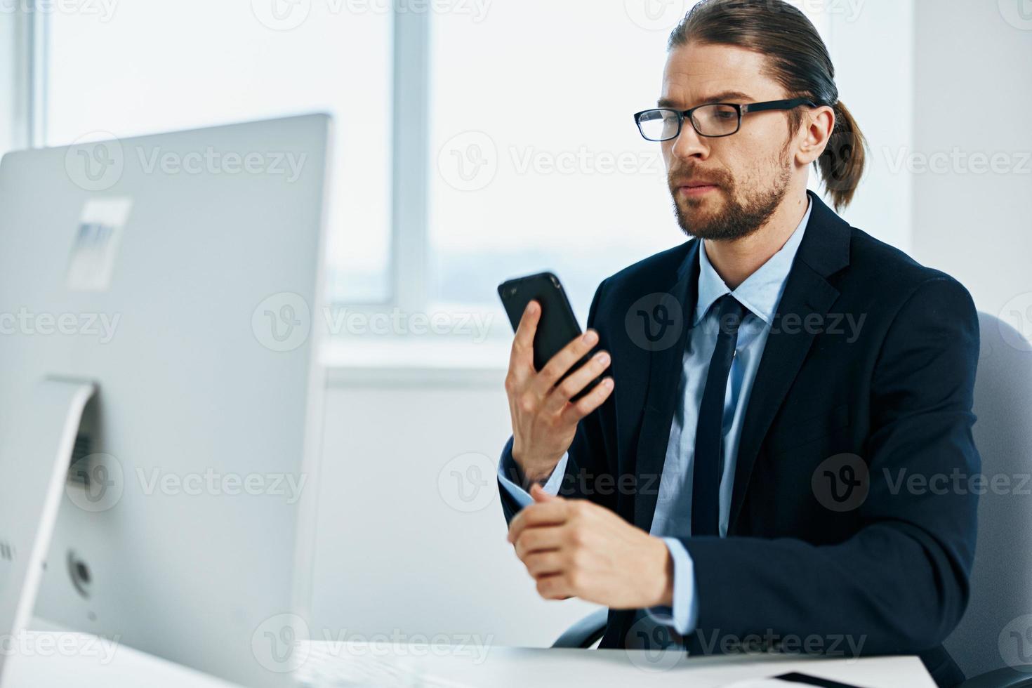 office worker sitting at a desk in front of a computer Lifestyle photo