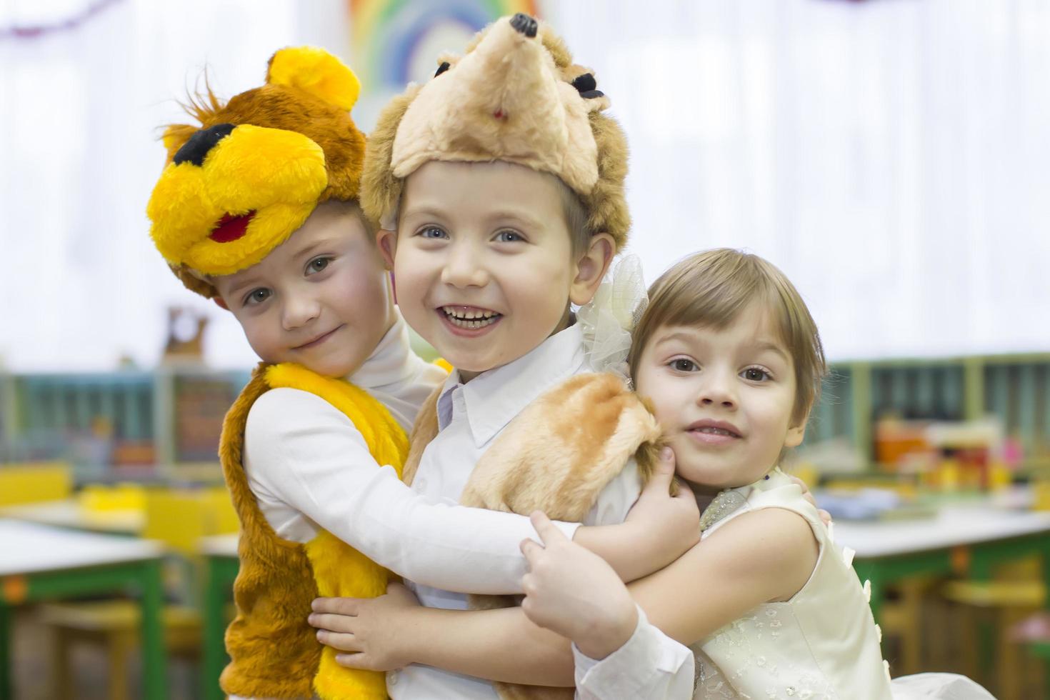 Morning party in kindergarten.Joyful children from kindergarten at Christmas morning. Little boys and girls in carnival costumes. photo