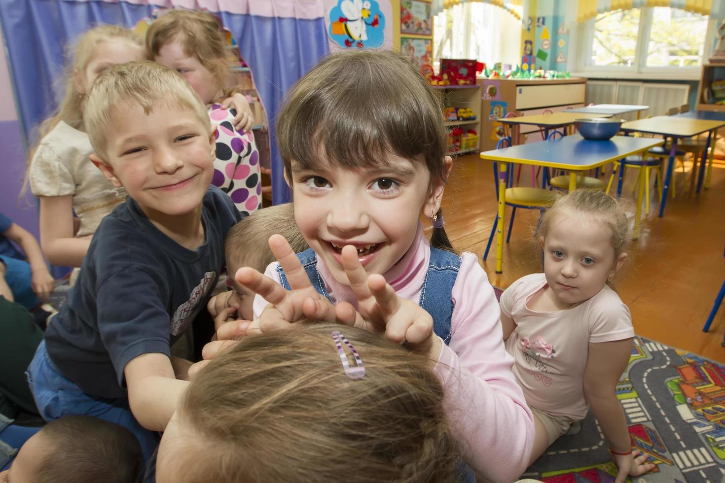 Cheerful children in kindergarten. A group of six-year-old boys and girls. photo