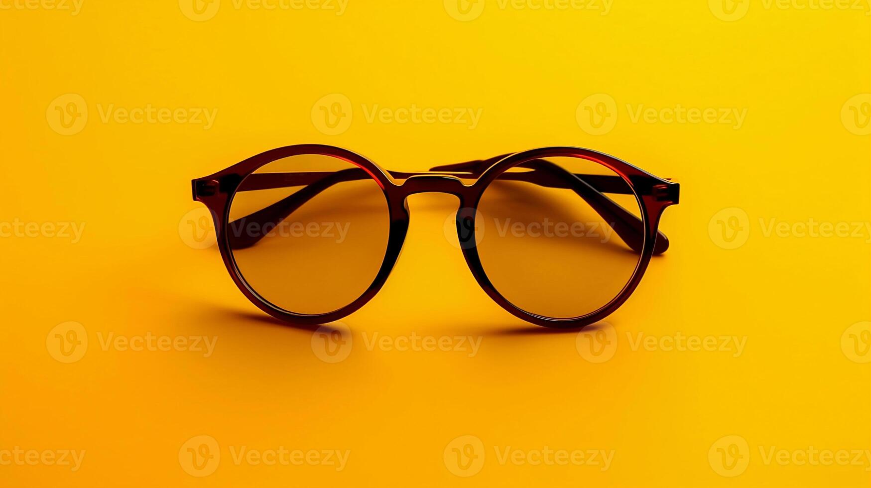 Black sunglasses on yellow background summer accessories photo