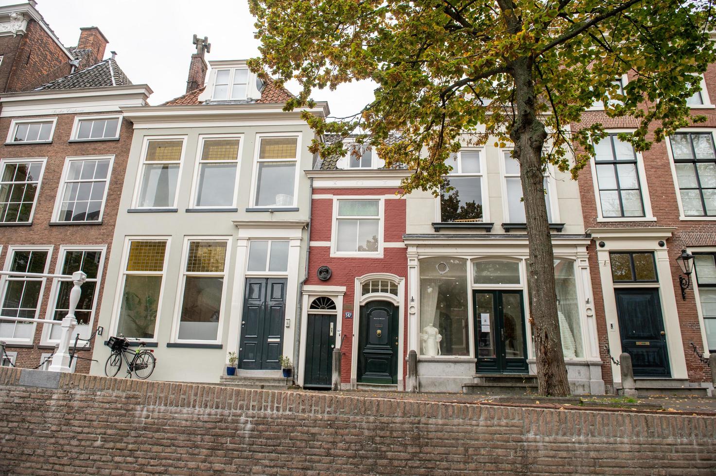 The Netherlands, Delft, October 2022. The smallest house in Delft with two doors. red house photo