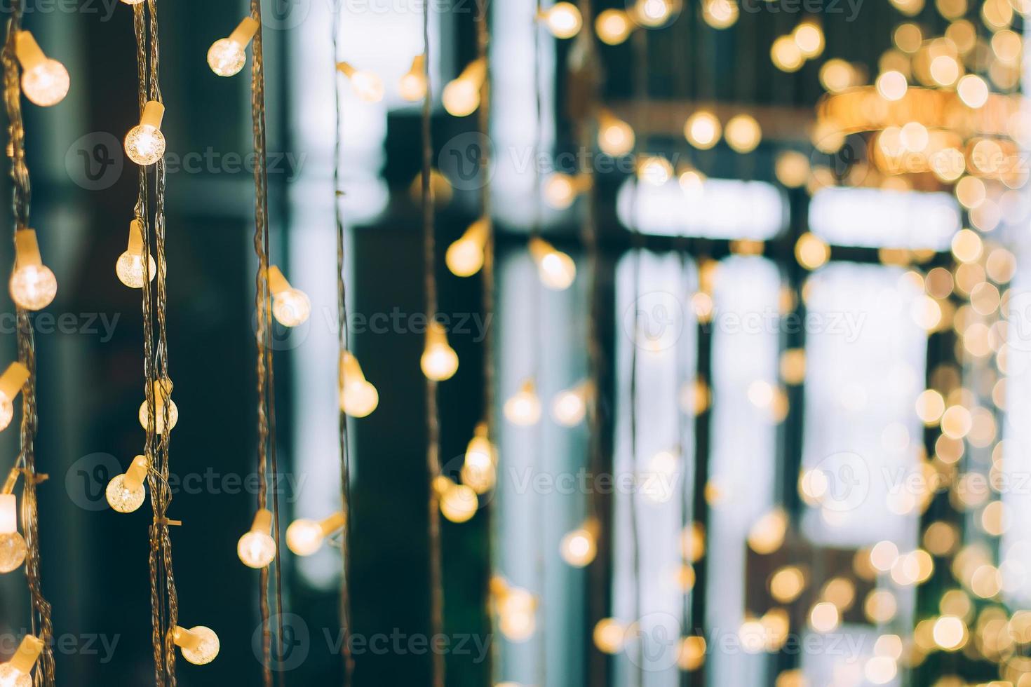 Abstract blurred of blue and silver glittering shine bulbs lights background. Xmas holiday backdrop photo