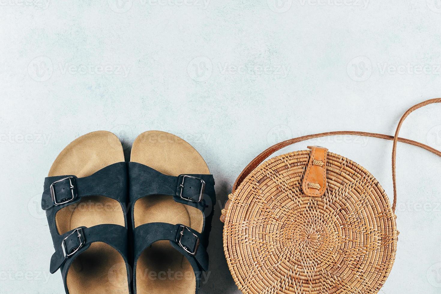 Casual Women's summer sandals and fashionable organic rattan bag. Vacation, travel concept. Top view photo