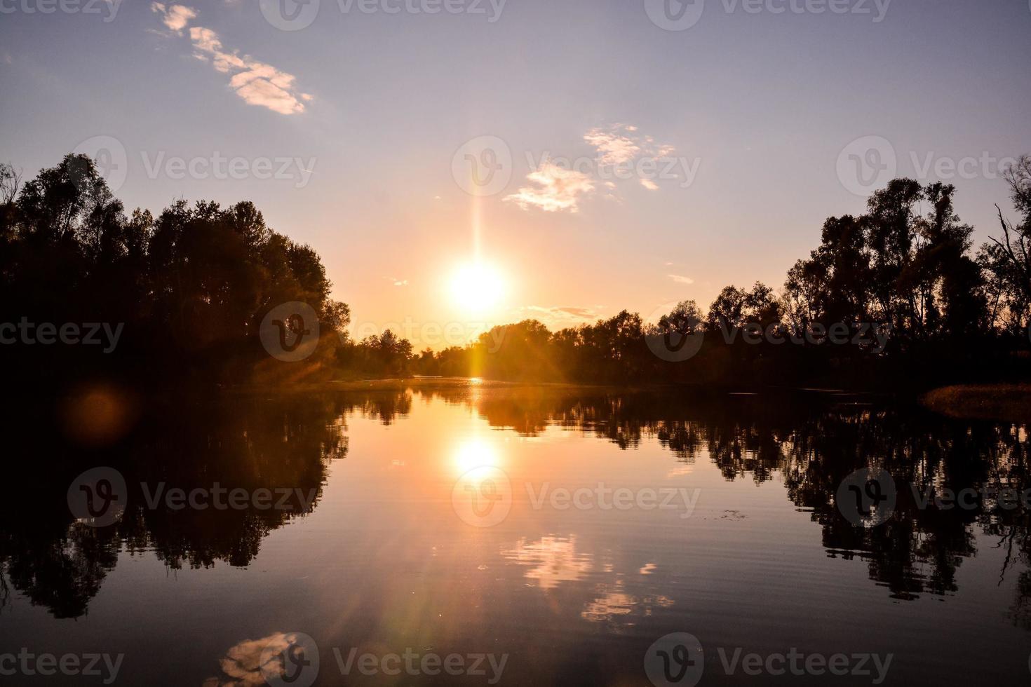 Reflection of trees on the water photo