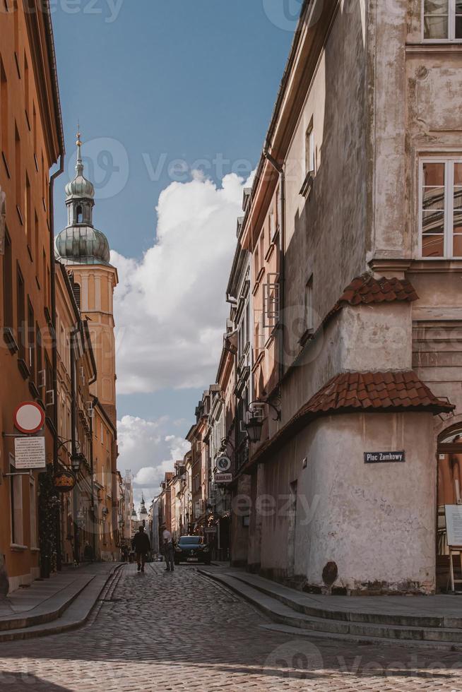 historic street with old tenement houses in the Warsaw Old Town in Poland on a summer day photo